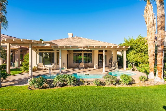 rear view of house with a patio, a yard, and ceiling fan