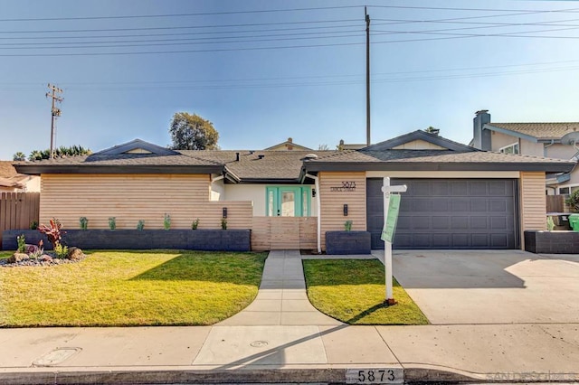 single story home featuring a garage and a front yard