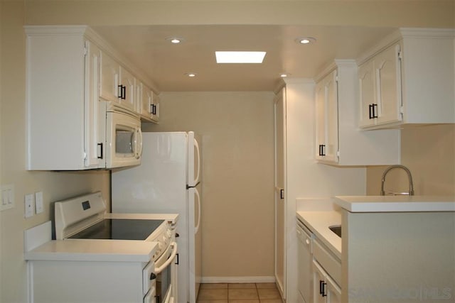 kitchen featuring white cabinetry, light tile patterned floors, and white appliances