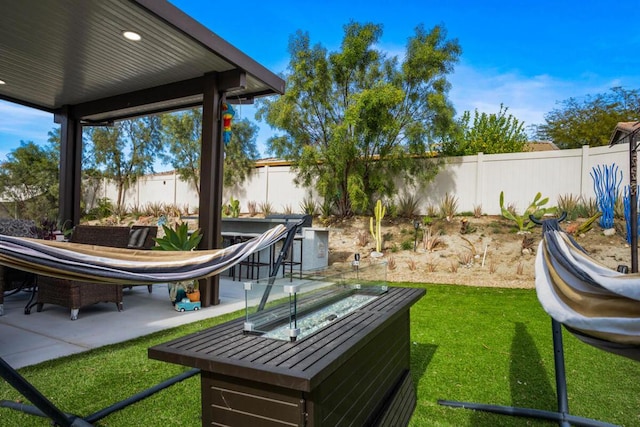 view of yard with a patio and an outdoor fire pit