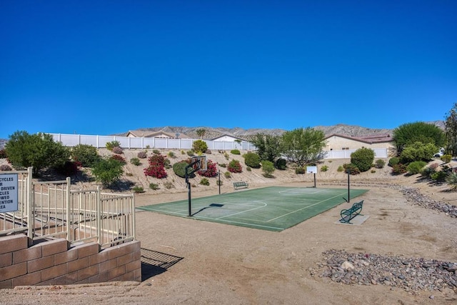 view of property's community with a mountain view and basketball court