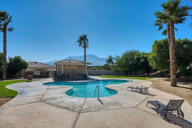 view of pool featuring a mountain view and a patio area