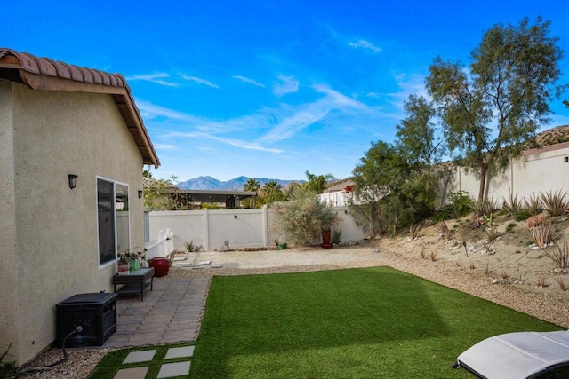 view of yard with a mountain view and a patio area