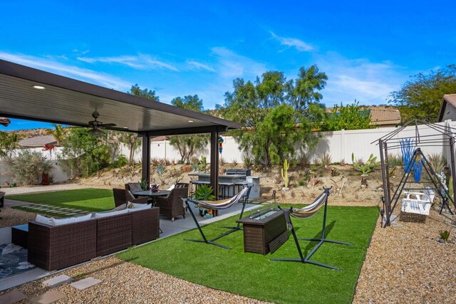 view of yard featuring ceiling fan, outdoor lounge area, and a patio area