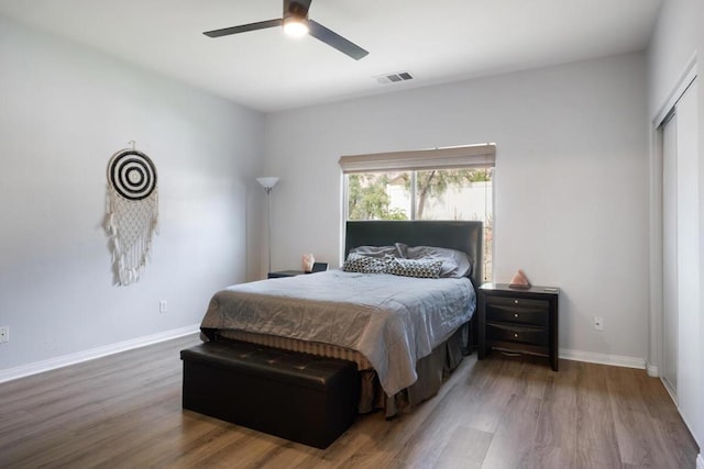 bedroom featuring ceiling fan, wood-type flooring, and a closet