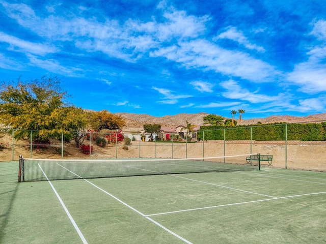 view of tennis court with a mountain view