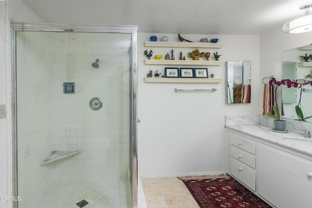 bathroom with an enclosed shower, vanity, and tile patterned floors