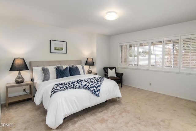 carpeted bedroom with baseboards