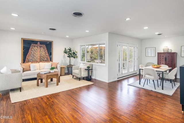 living room featuring recessed lighting, wood finished floors, visible vents, baseboards, and french doors