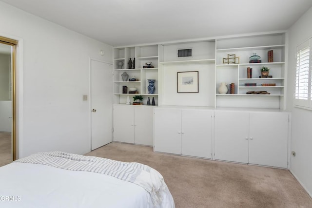 bedroom featuring visible vents and light colored carpet