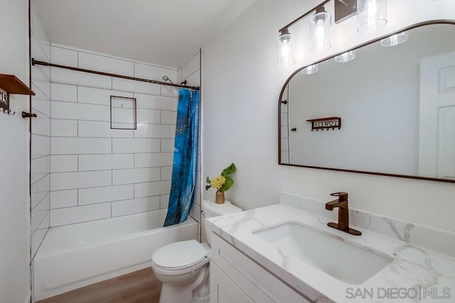 full bathroom featuring shower / bathtub combination with curtain, vanity, wood-type flooring, and toilet