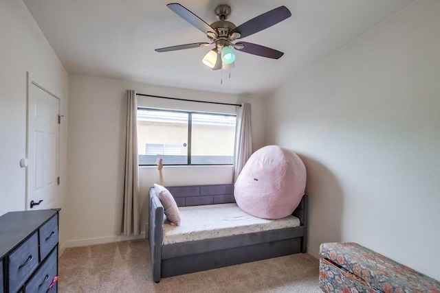 living area with ceiling fan and light colored carpet