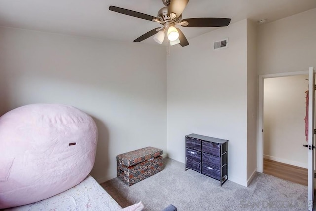 sitting room with light colored carpet and ceiling fan