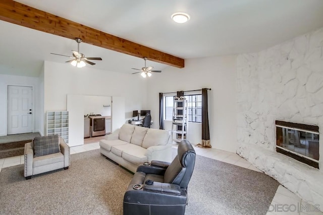 living room featuring tile patterned floors, lofted ceiling with beams, and a large fireplace