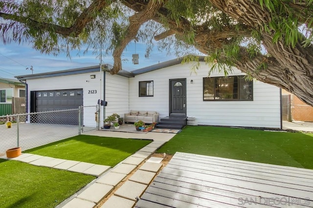 ranch-style home with a garage and a front yard