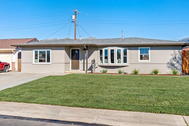 single story home with a garage and a front lawn