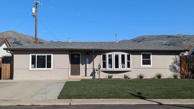 ranch-style house with a mountain view and a front lawn