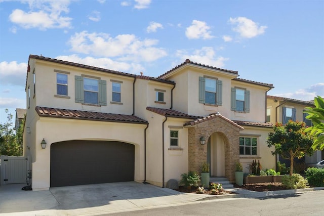 mediterranean / spanish-style house with a garage