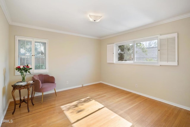 sitting room featuring hardwood / wood-style flooring and ornamental molding