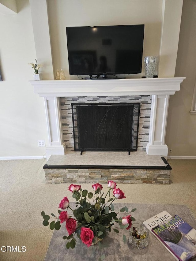 details featuring carpet flooring and a stone fireplace