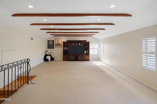 carpeted living room with lofted ceiling with beams