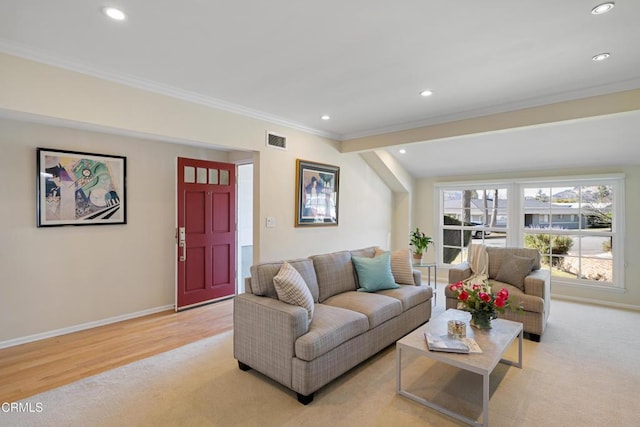 living room with crown molding and light hardwood / wood-style flooring