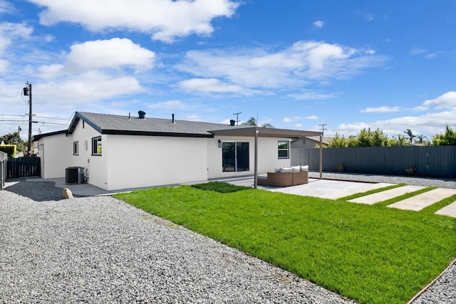 rear view of property with a patio, an outdoor hangout area, a yard, and central AC unit