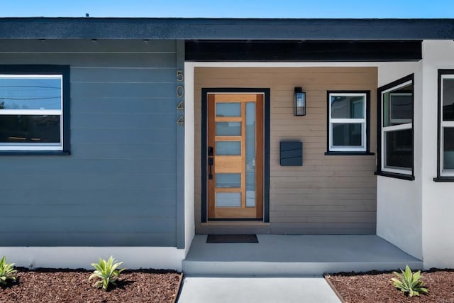 view of exterior entry with covered porch