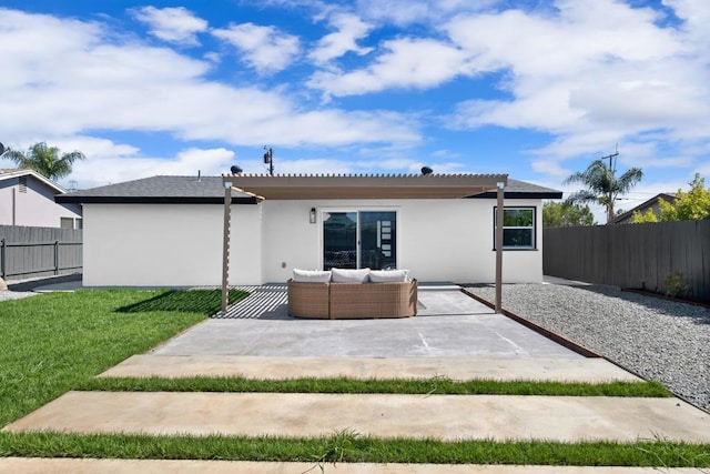 rear view of property featuring an outdoor living space, a yard, and a patio area