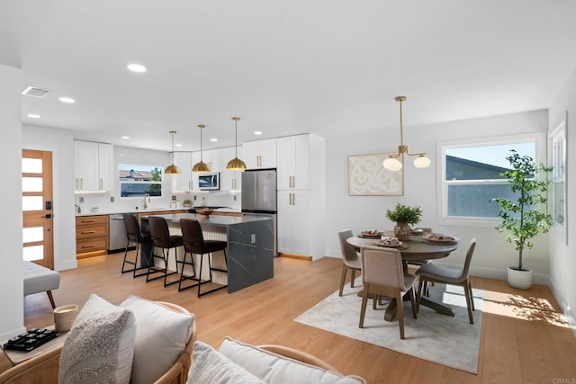 interior space with a notable chandelier and light hardwood / wood-style flooring