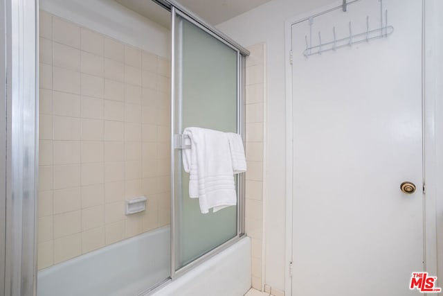 bathroom featuring shower / bath combination with glass door