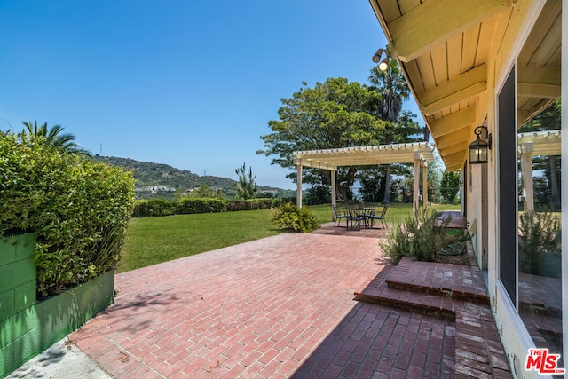 view of patio / terrace featuring a pergola and a mountain view