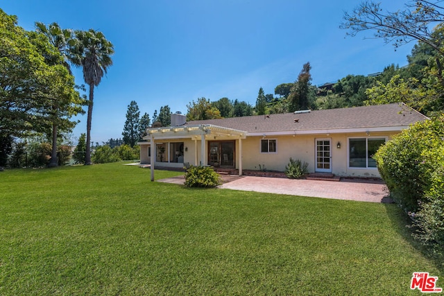 back of house with a yard, a pergola, and a patio area