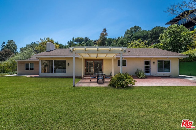 rear view of property with a pergola, a yard, and a patio area