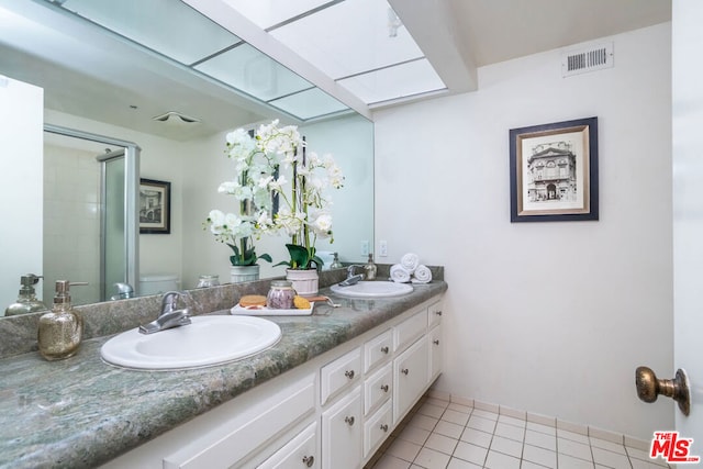 bathroom with tile patterned floors, toilet, an enclosed shower, and vanity