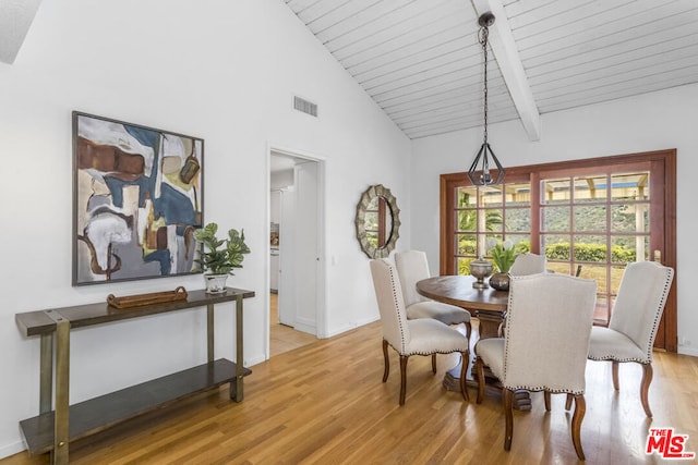 dining area with high vaulted ceiling, beam ceiling, light hardwood / wood-style floors, and wooden ceiling