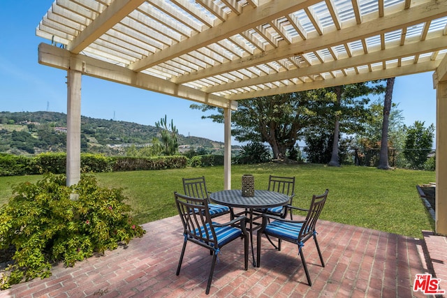 view of patio / terrace with a mountain view and a pergola