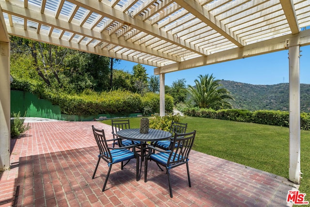 view of patio / terrace featuring a pergola and a mountain view