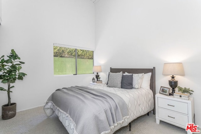 bedroom with light colored carpet