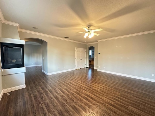 unfurnished room with crown molding, dark wood-type flooring, and ceiling fan