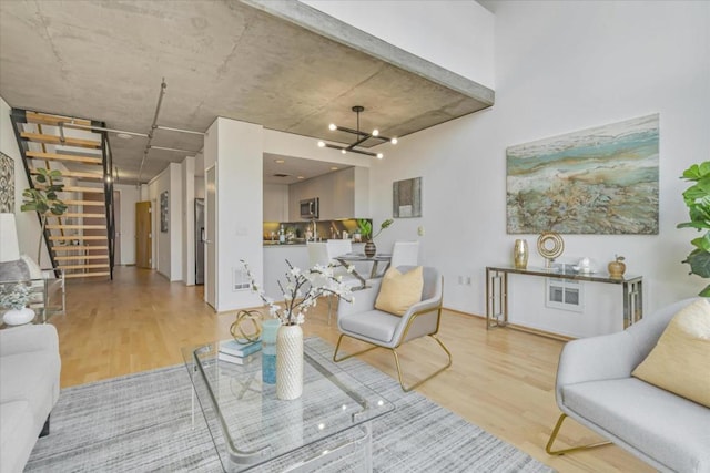 living room with hardwood / wood-style flooring and a chandelier