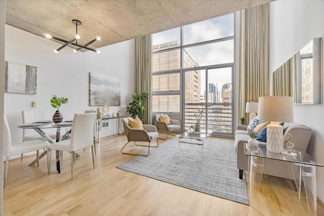 sitting room featuring hardwood / wood-style floors, a notable chandelier, and floor to ceiling windows