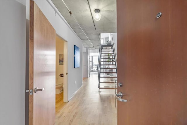 hallway with light hardwood / wood-style flooring