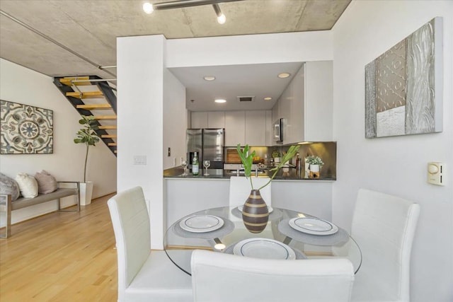 dining area with light hardwood / wood-style floors