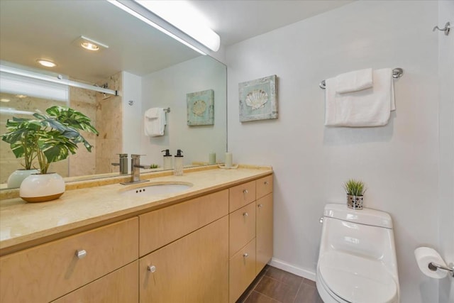 bathroom with vanity, tile patterned floors, and toilet