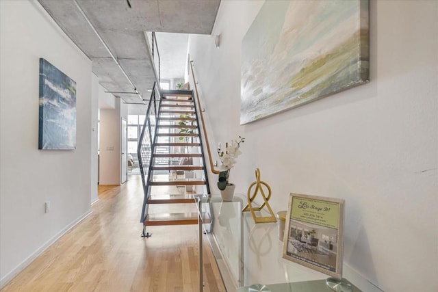 stairway with hardwood / wood-style flooring