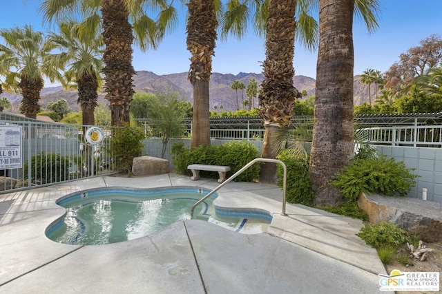 view of swimming pool with a patio and a mountain view