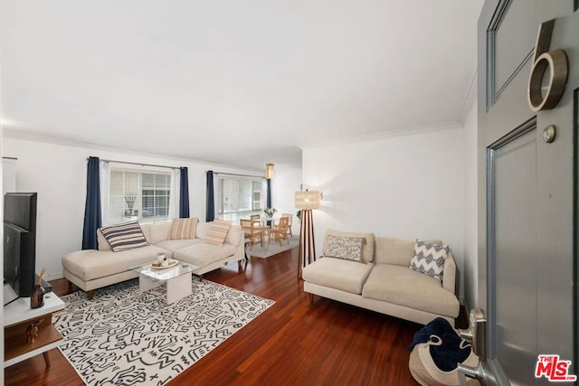 living room with dark hardwood / wood-style flooring and crown molding