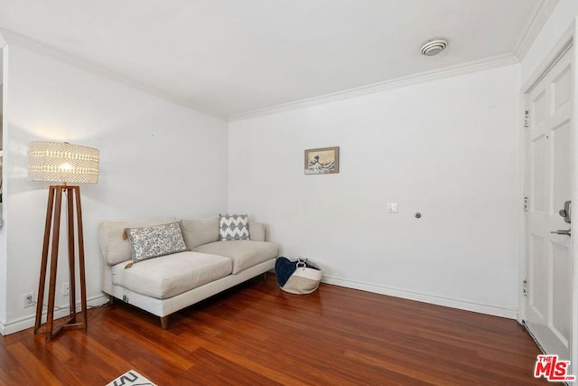 living area with crown molding and dark hardwood / wood-style floors