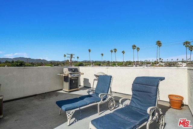 view of patio / terrace with area for grilling and a mountain view